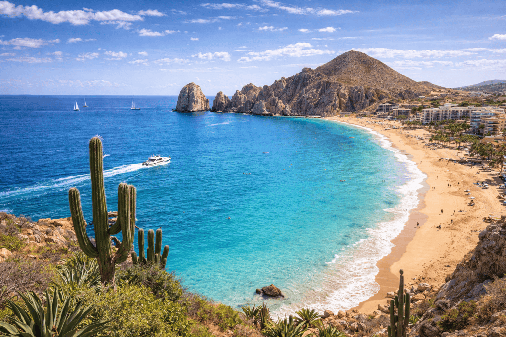 Cabo San Lucas Mexico beach with El Arco rock formation and desert cliffs