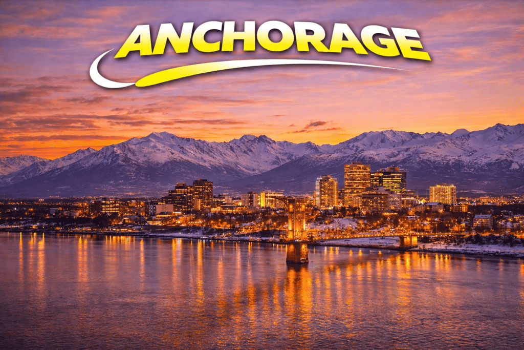 Anchorage skyline with mountains at sunset and golden sky for cheap flights travel page